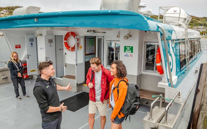 Crew assisting tourists boarding the Stewart Island Ferry.