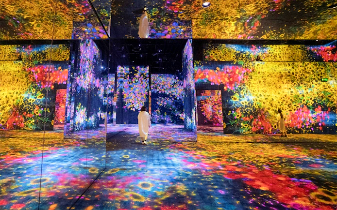 Immersive digital art installation at teamLab SuperNature Macau with vibrant floral projections.