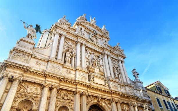 Facade of Chiesa di Santa Maria del Giglio with statues and columns, Venice, Italy.