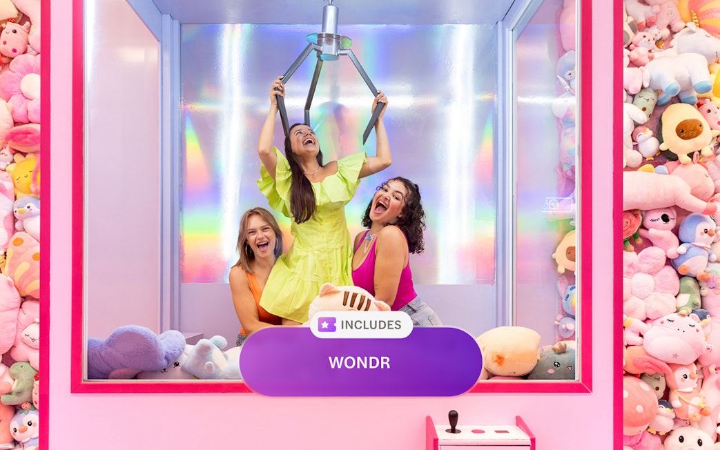 Women enjoying a claw machine experience at WONDR Amsterdam.