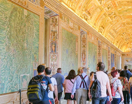 Visitors exploring the ornate Gallery of Maps in the Vatican Museums.