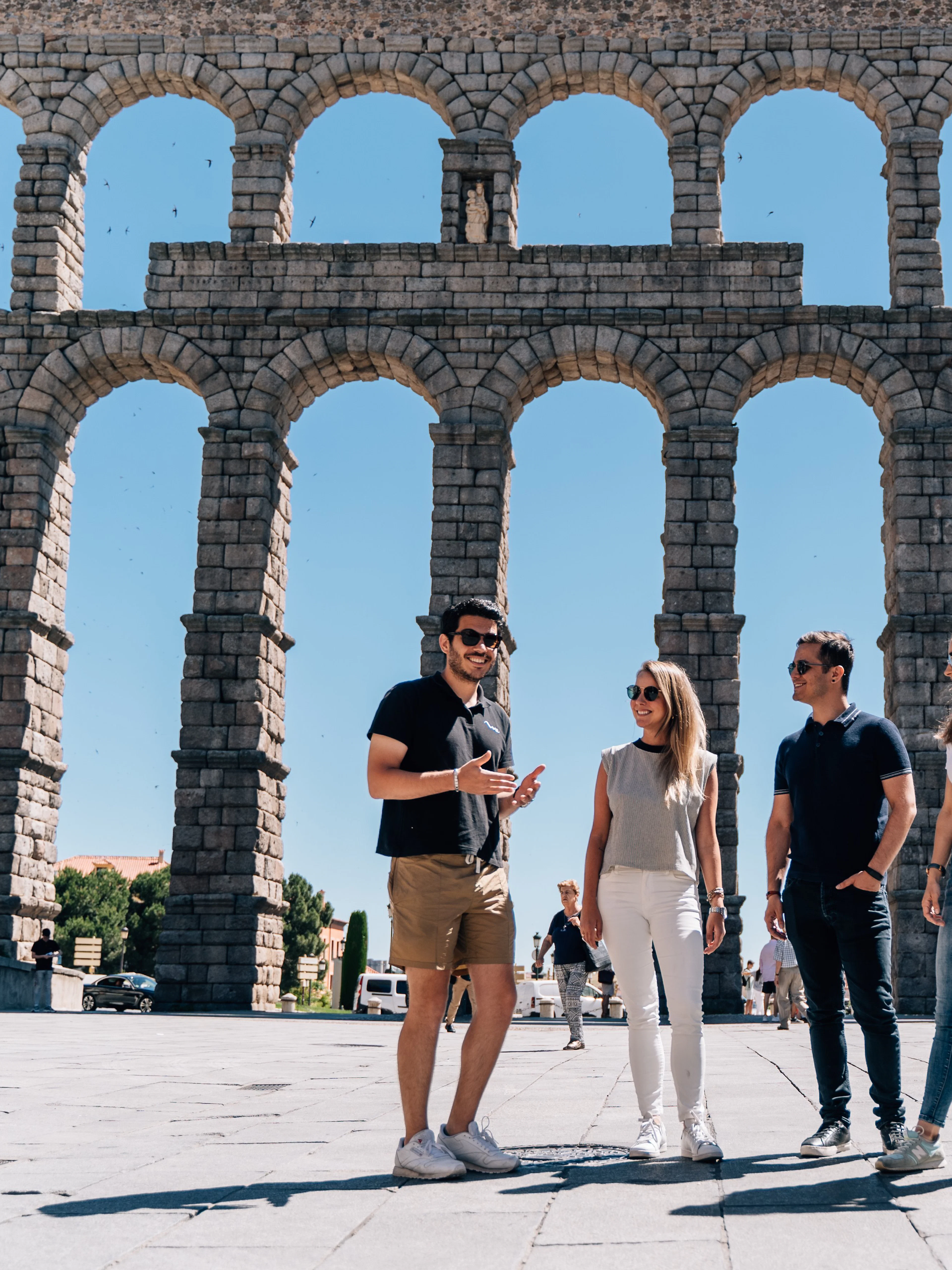 Tourist group with guide at the Aqueduct of Segovia, Spain.