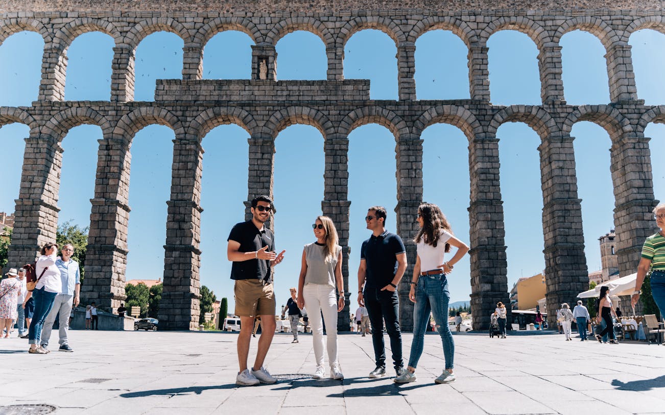 Tourist group with guide at the Aqueduct of Segovia, Spain.