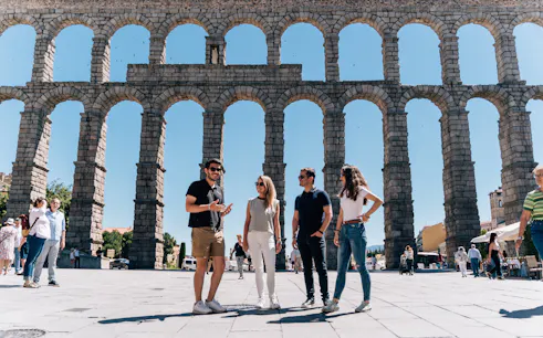 Tourist group with guide at the Aqueduct of Segovia, Spain.