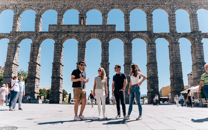 Tourist group with guide at the Aqueduct of Segovia, Spain.