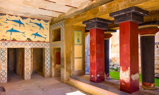Knossos Palace interior with ancient red pillars and frescoes, Crete, Greece.
