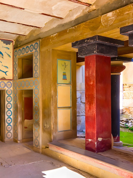 Knossos Palace interior with frescoes and red columns, Crete.