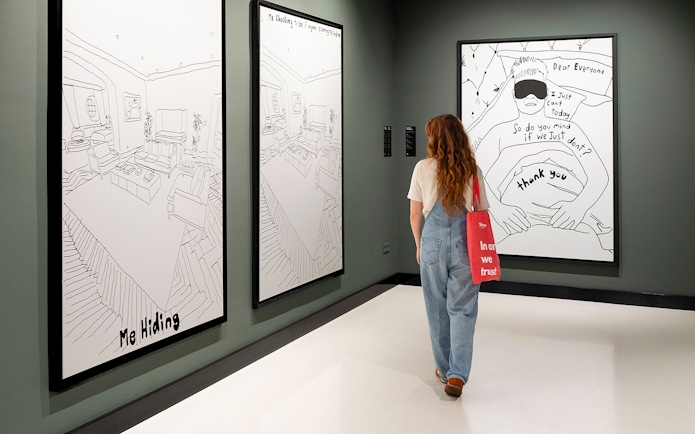 Visitor viewing Banksy artworks at Moco Museum Barcelona.