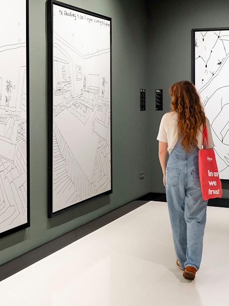 Visitor viewing Banksy artworks at Moco Museum Barcelona.