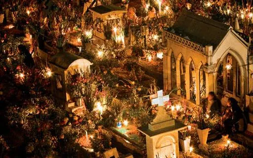 Mixquic cemetery illuminated with candles during Day of the Dead celebration.
