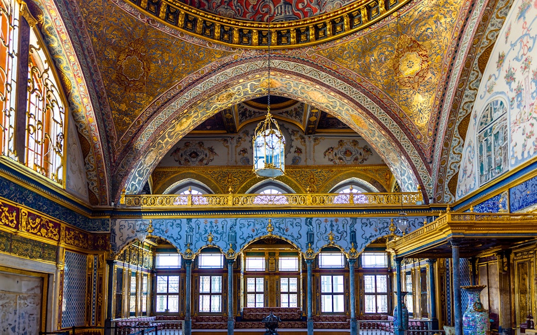 Interior of Topkapi Palace with ornate arches and detailed gold decorations, Istanbul.