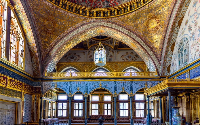 Interior of Topkapi Palace with ornate arches and detailed gold decorations, Istanbul.