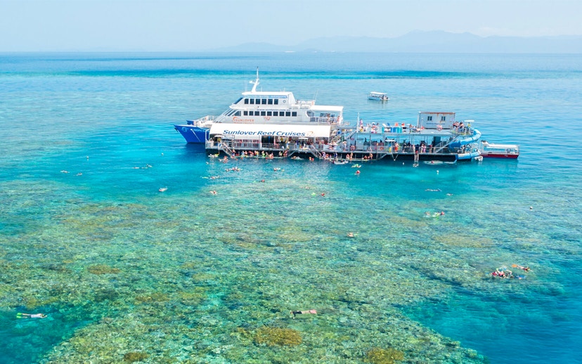 Aerial view of pontoon at Moore Reef, Great Barrier Reef with snorkelers in clear water.