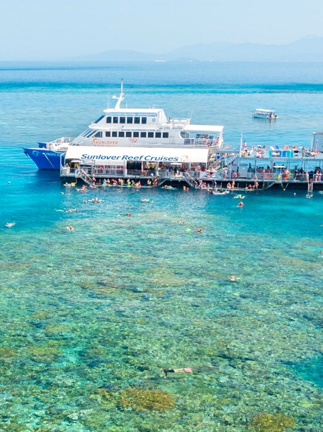 Aerial view of pontoon at Moore Reef, Great Barrier Reef with snorkelers in clear water.