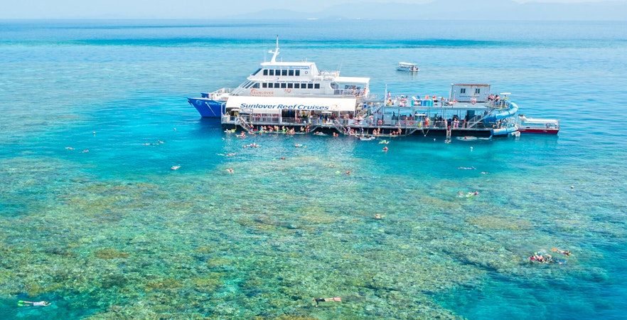 Aerial view of pontoon at Moore Reef, Great Barrier Reef with snorkelers in clear water.