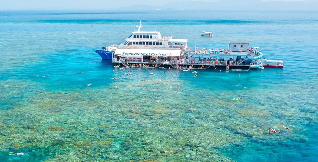 Aerial view of pontoon at Moore Reef, Great Barrier Reef with snorkelers in clear water.