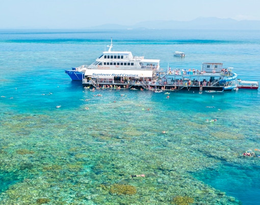 Aerial view of pontoon at Moore Reef, Great Barrier Reef with snorkelers in clear water.