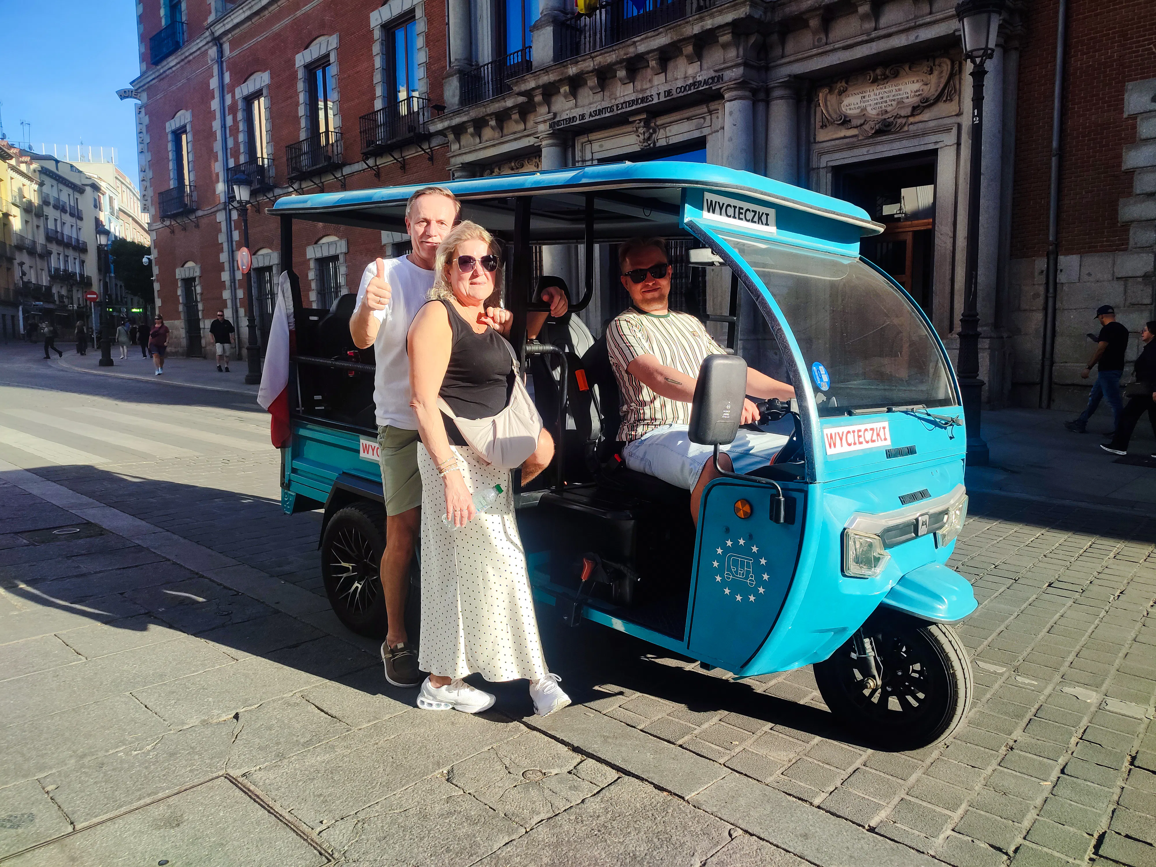 Tourists in a tuk-tuk during a private 2-hour tour with a local guide in Madrid.