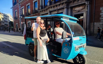 Tourists in a tuk-tuk during a private 2-hour tour with a local guide in Madrid.