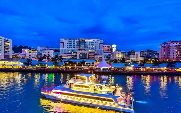 Cruise ship illuminated at night in Kota Kinabalu harbor, North Borneo.