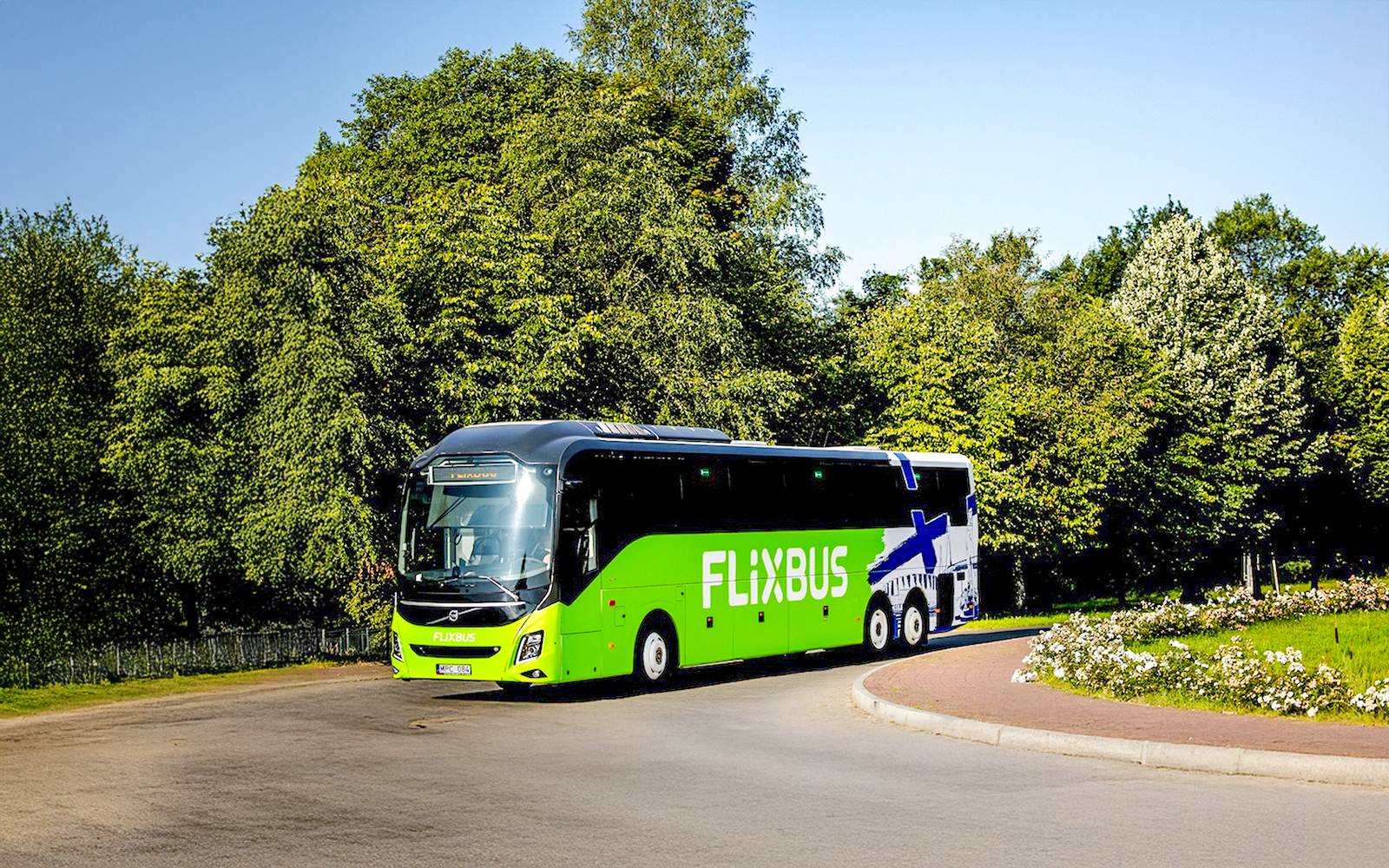 FlixBus traveling through a scenic area, connecting Efteling and Amsterdam.