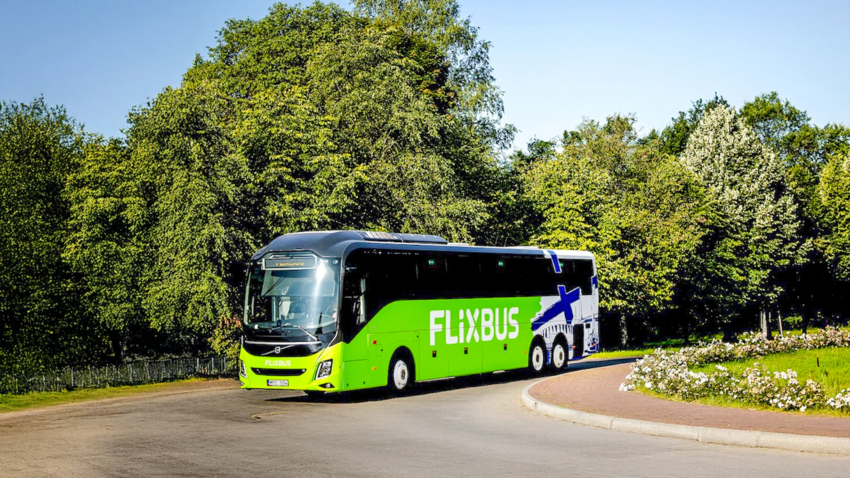 FlixBus traveling through a scenic area, connecting Efteling and Amsterdam.