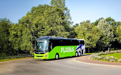 FlixBus traveling through a scenic area, connecting Efteling and Amsterdam.