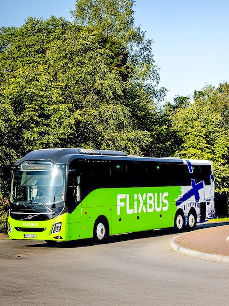 FlixBus traveling through a scenic area, connecting Efteling and Amsterdam.