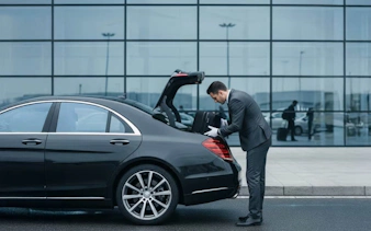 Private car transfer at Budapest Airport with driver loading luggage.