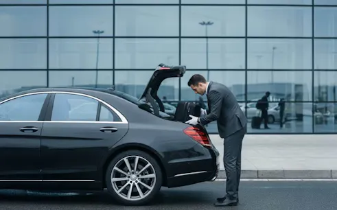 Private car transfer at Budapest Airport with driver loading luggage.