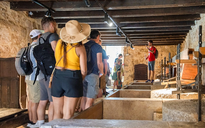 Tour group inside a historic building during Krka Waterfalls tour from Split.
