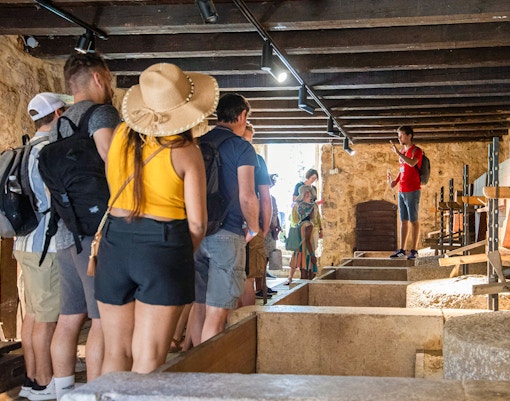 Tour group inside a historic building during Krka Waterfalls tour from Split.