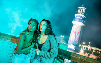 Visitors experiencing Howl-o-Scream at SeaWorld Orlando with lighthouse in background.