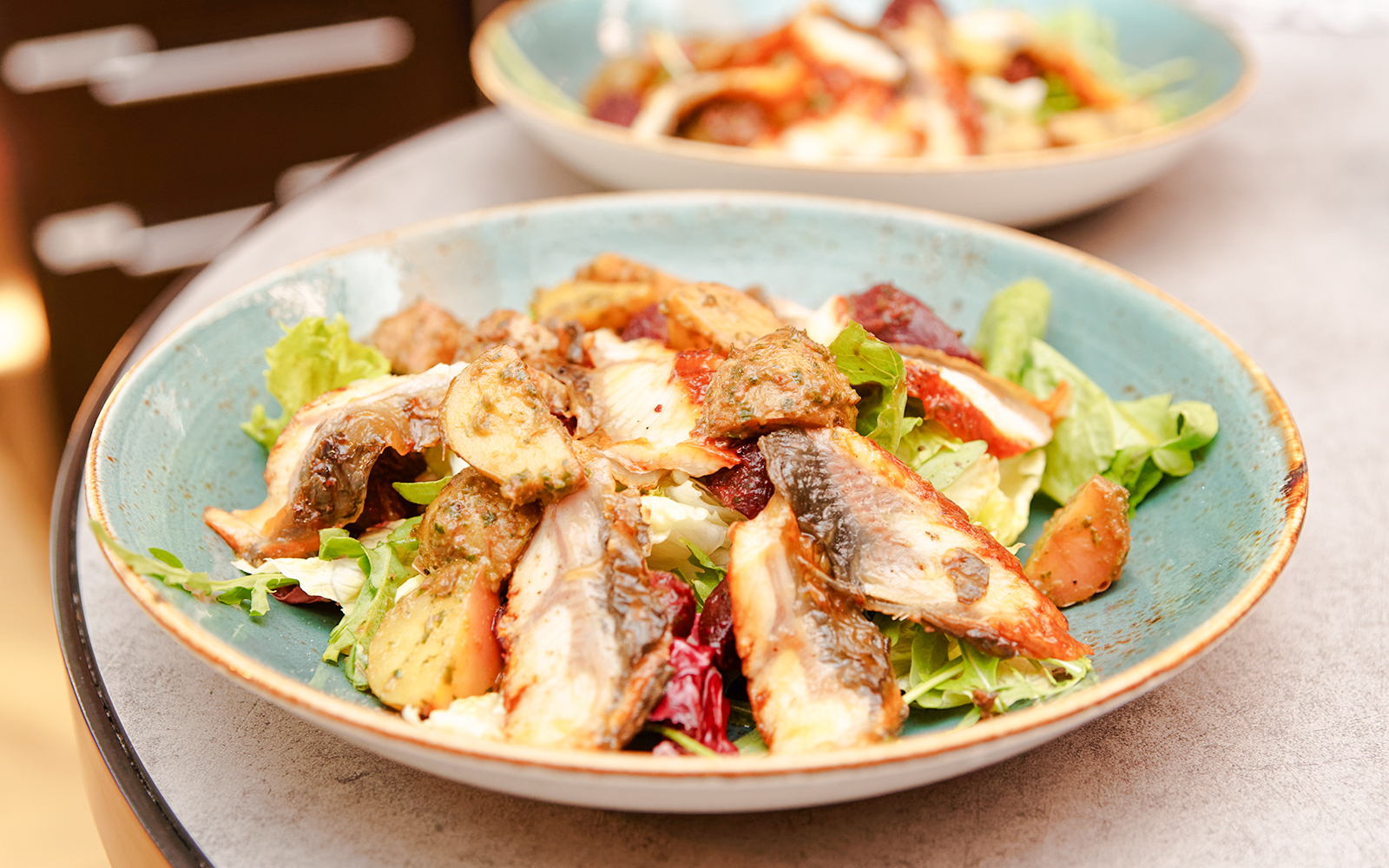 Smoked eel salad with greens and vegetables in Douro Valley.