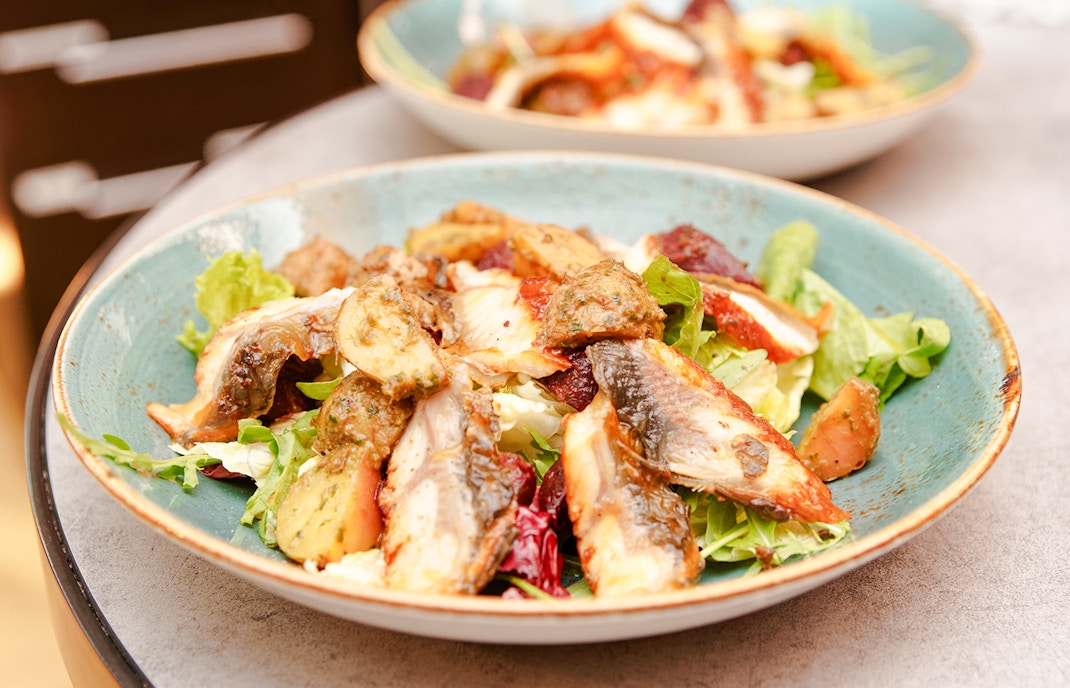 Smoked eel salad with greens and vegetables in Douro Valley.