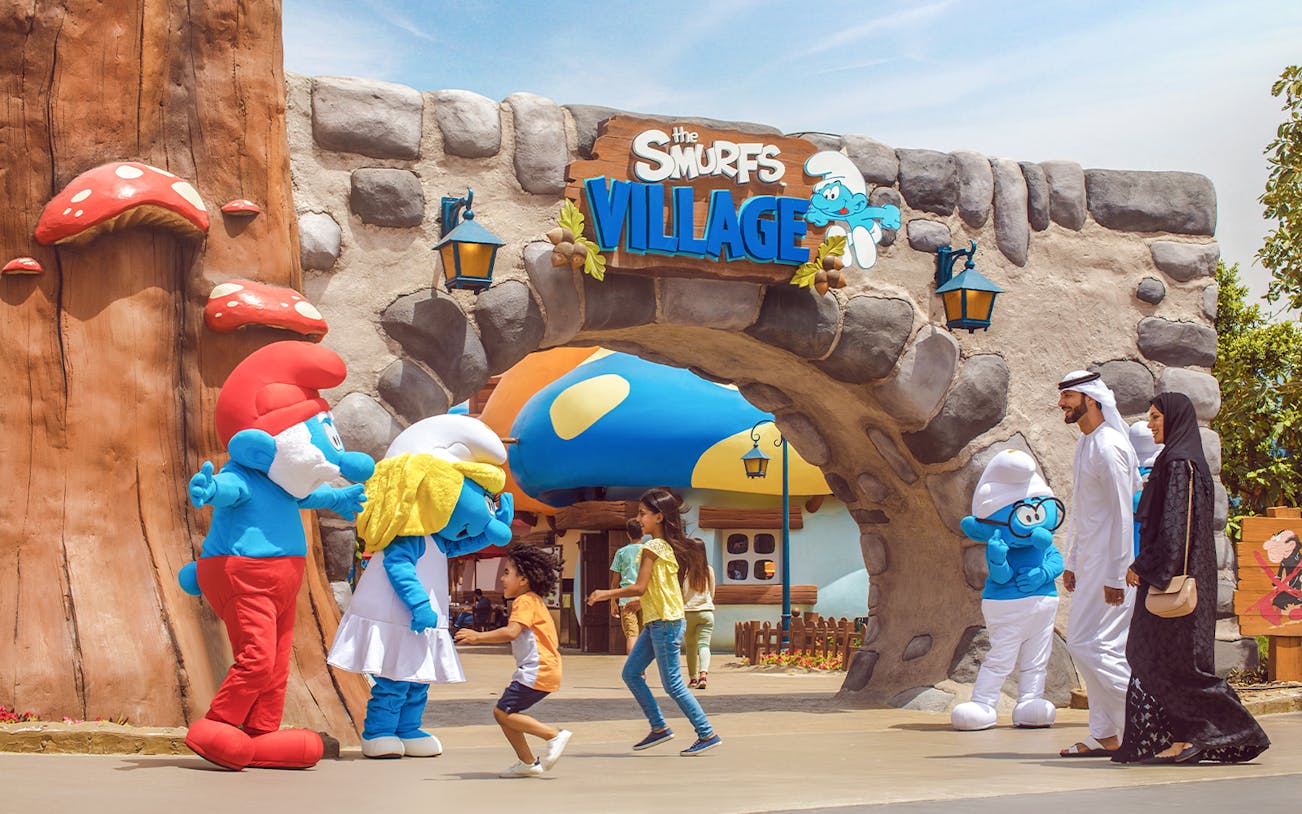 Visitors interacting with Smurf characters at Smurfs Village, Motiongate Dubai.