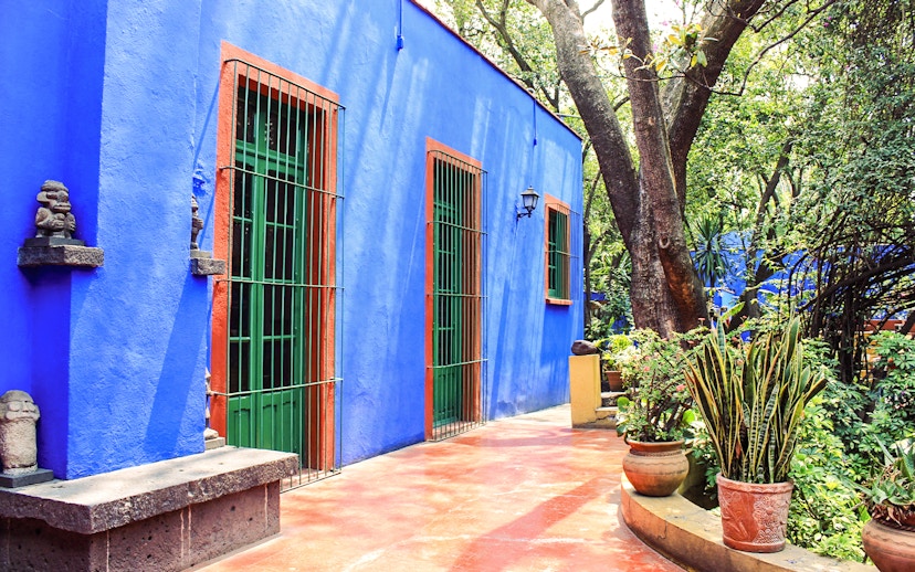 Frida Kahlo Museum exterior with blue walls and garden in Mexico City.