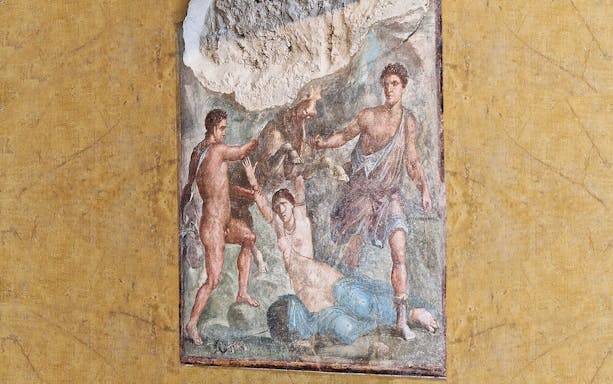 Ancient fresco depicting mythological scene in Pompeii ruins.