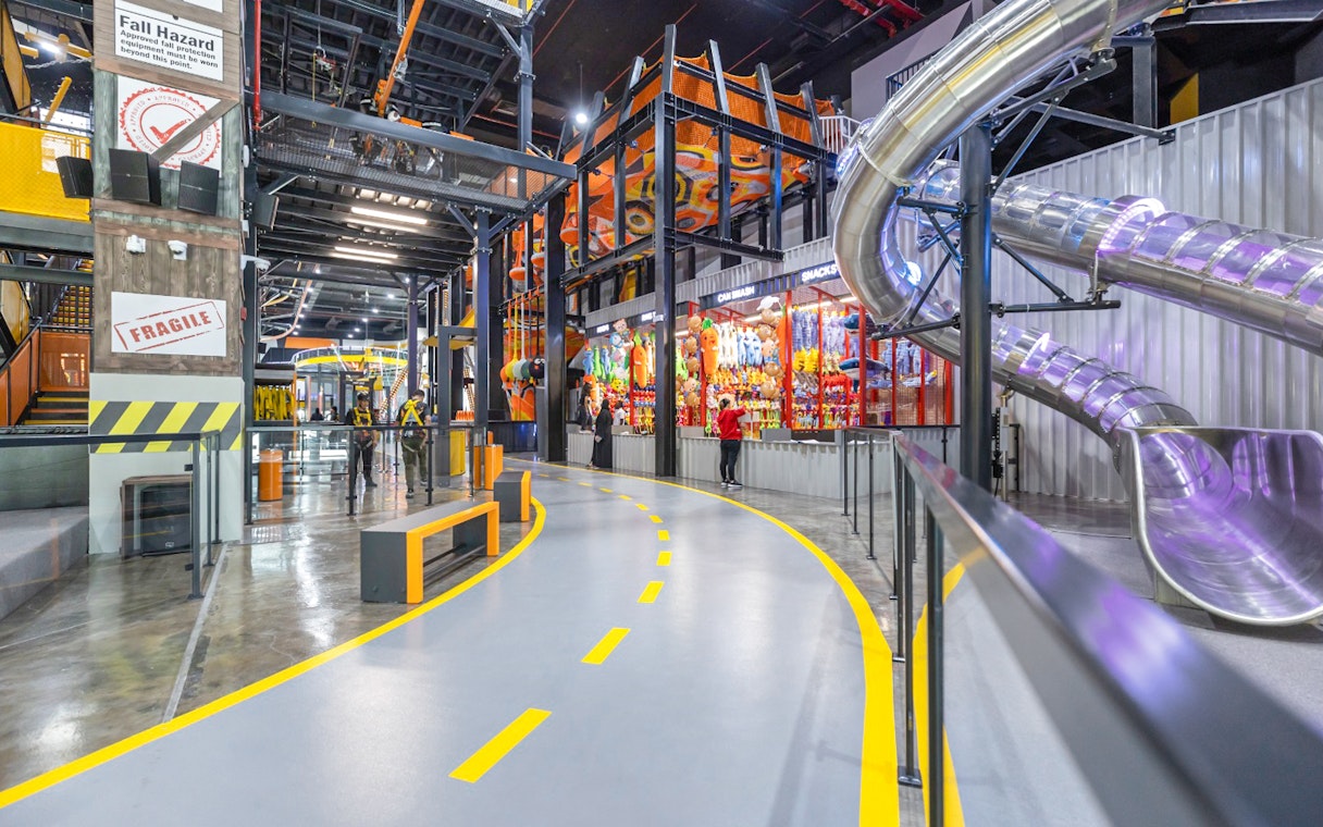 Indoor adventure park with slides and climbing structures at Adrenark Adventure.