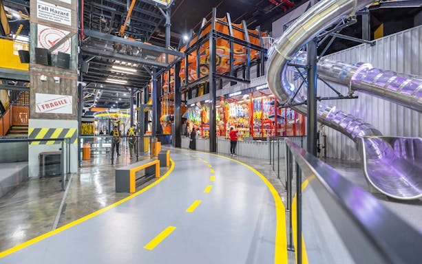 Indoor adventure park with slides and climbing structures at Adrenark Adventure.