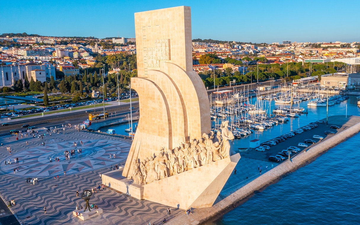 Monument to the Discoveries in Lisbon with Jerónimos Monastery in the background.