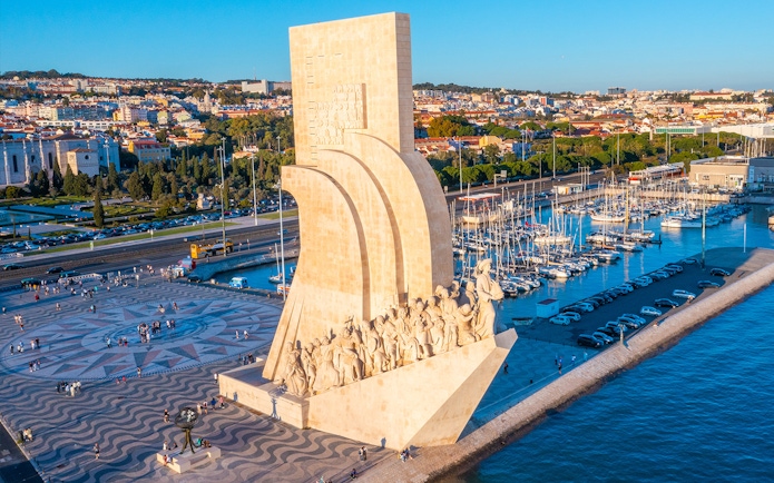 Monument to the Discoveries in Lisbon with Jerónimos Monastery in the background.