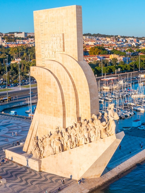 Monument to the Discoveries in Lisbon with Jerónimos Monastery in the background.