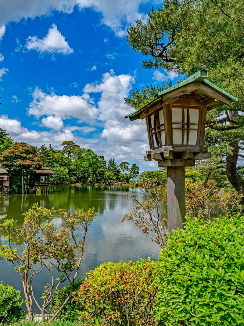 Kenroku-en garden with traditional lantern and pond in Kanazawa, Ishikawa, Japan.