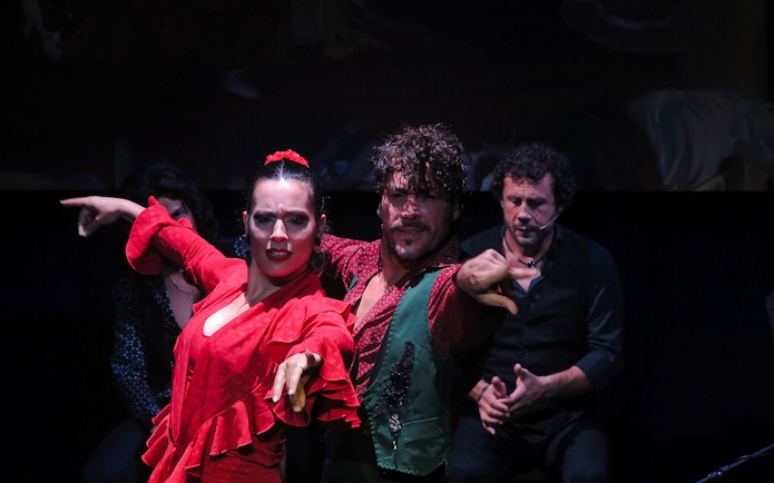 Flamenco dancers performing at Triana Theater in Seville.