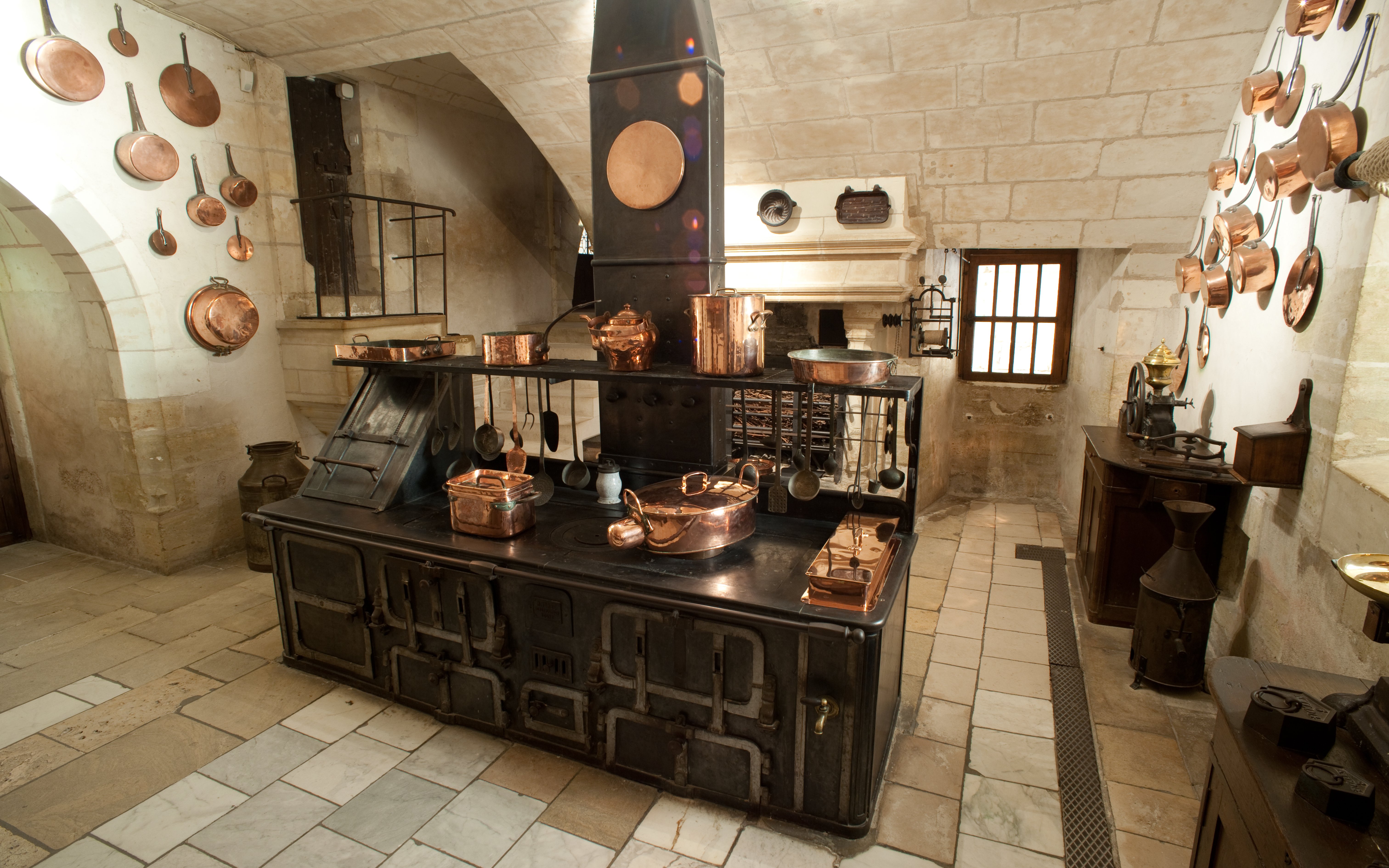 Chenonceau Castle kitchen with vintage stove and copper cookware.