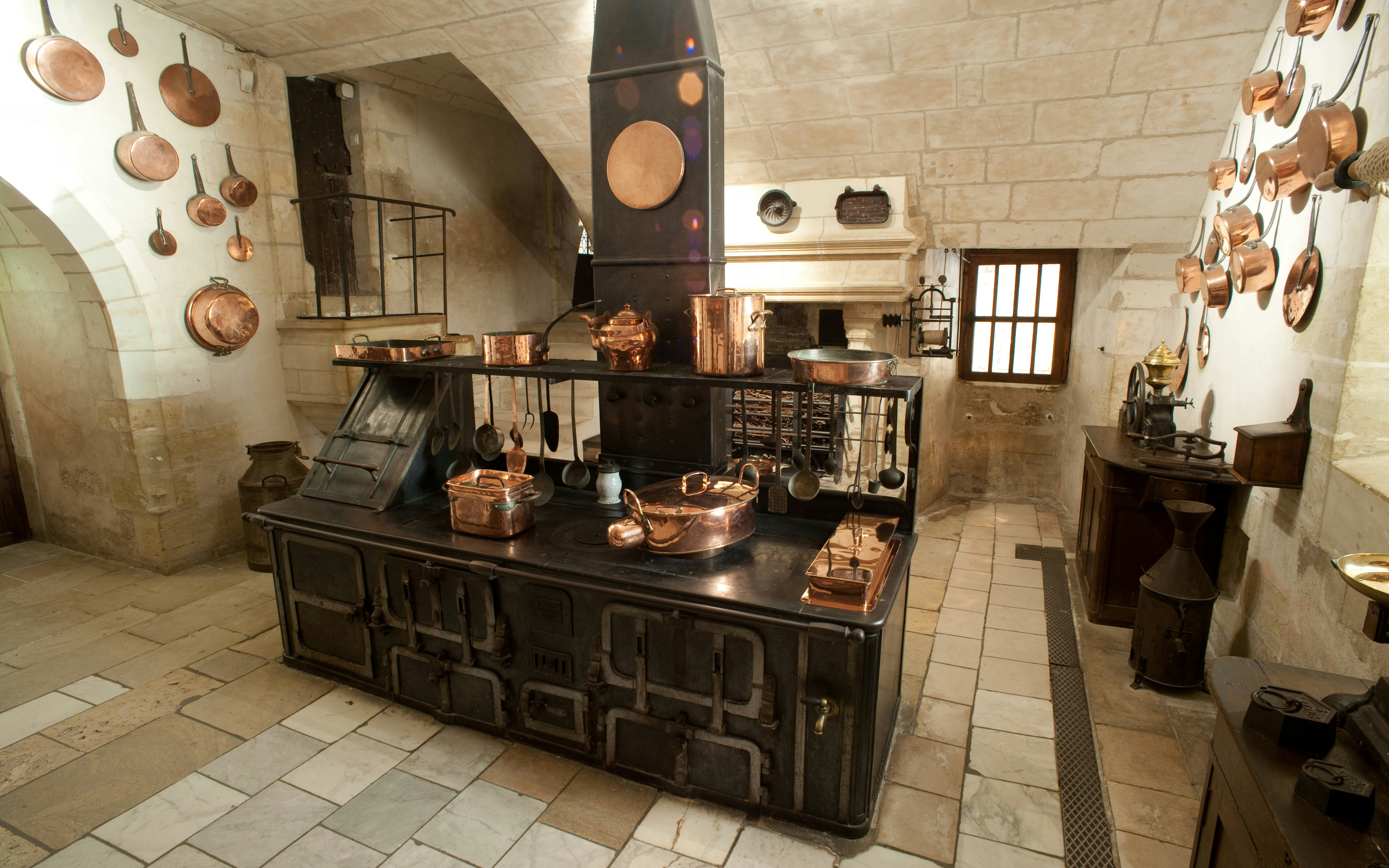 Chenonceau Castle kitchen with vintage stove and copper cookware.