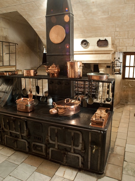 Chenonceau Castle kitchen with vintage stove and copper cookware.