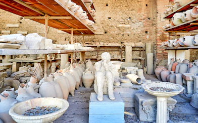 Ancient artifacts and plaster cast in Pompeii marketplace.