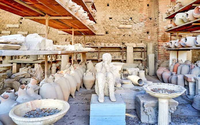 Ancient artifacts and plaster cast in Pompeii marketplace.